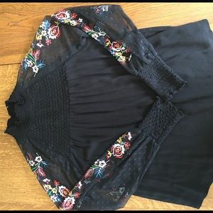 NWOT top with sexy sheer embroidered sleeves.